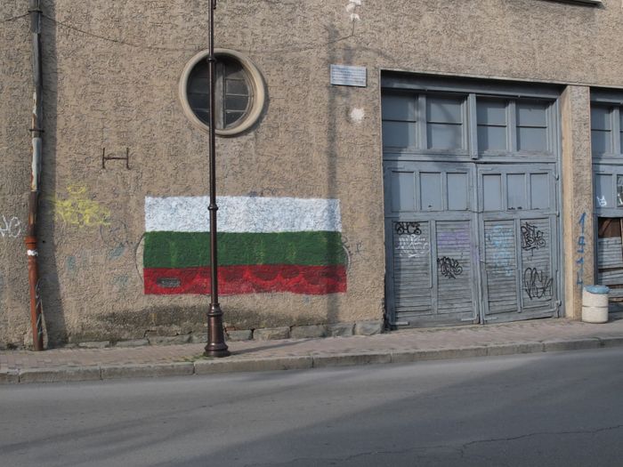 Flag is covering some ugly graffitty in the town center.