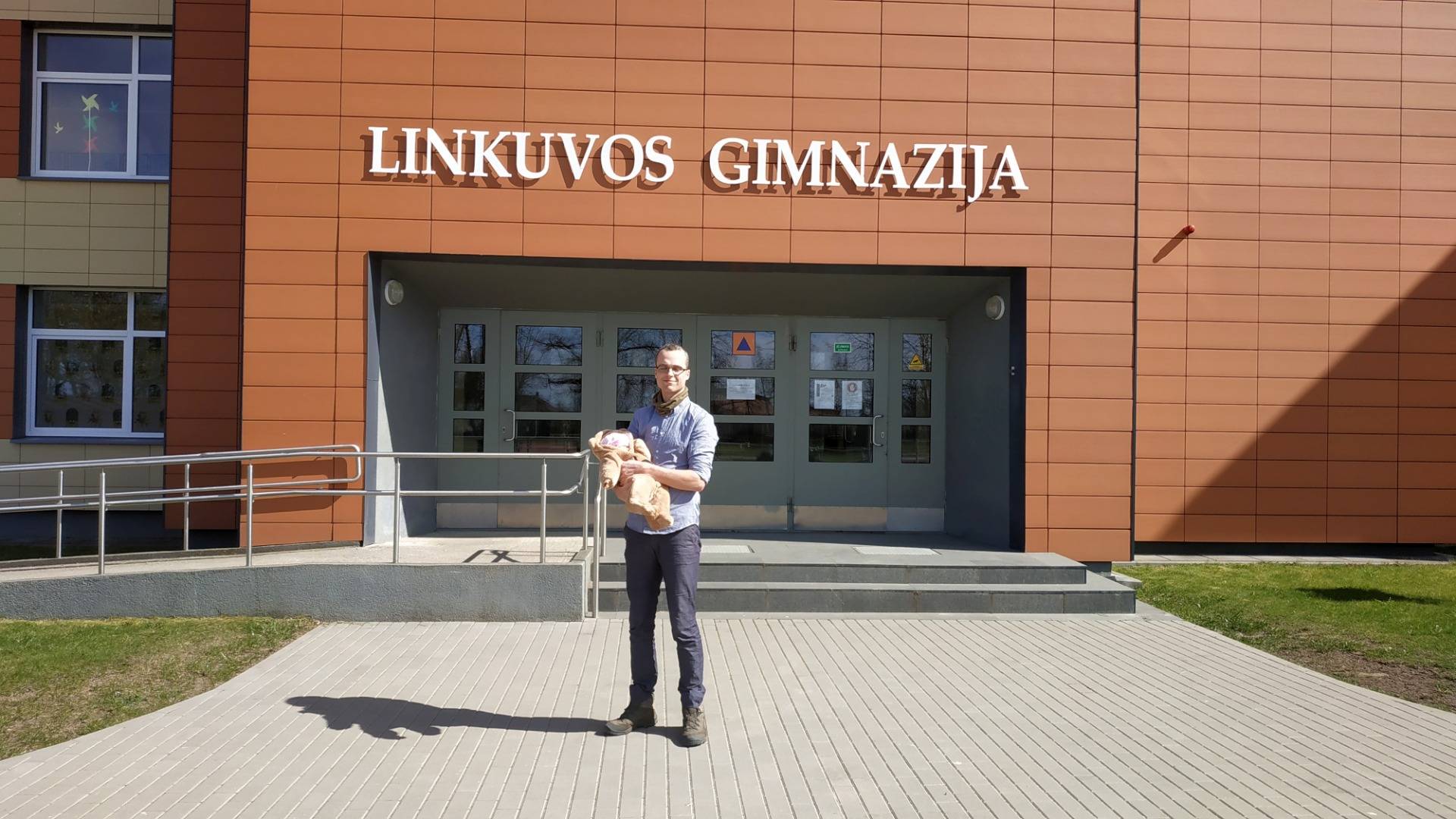 Tautvydas Šlevas (me) and my daughter Vakarė in front of the entrance to The Gymnasium of Linkuva