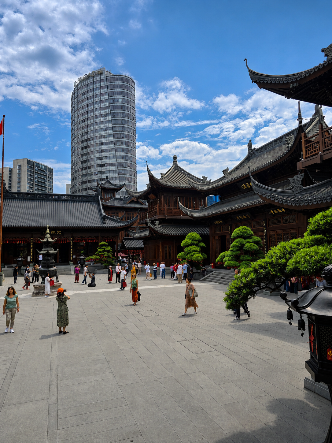 Traditional temple roofs beneath a modern Shanghai high-rise.