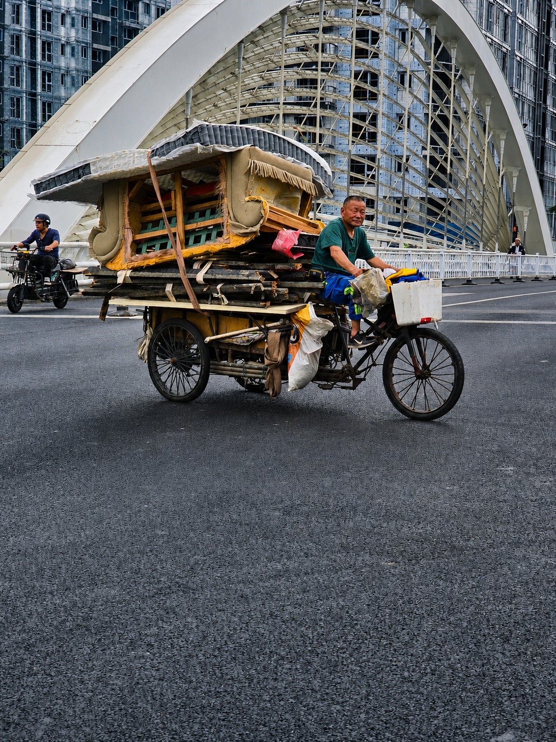 One of Shanghai’s small vehicles carrying an almost impossible load.