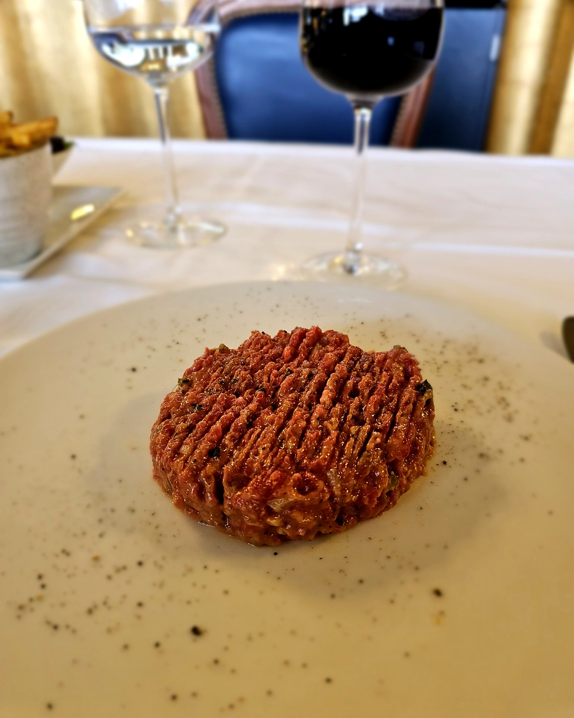 The steak tartare arrived with almost suspicious restraint, leaving the surrounding dining room to provide most of the drama.