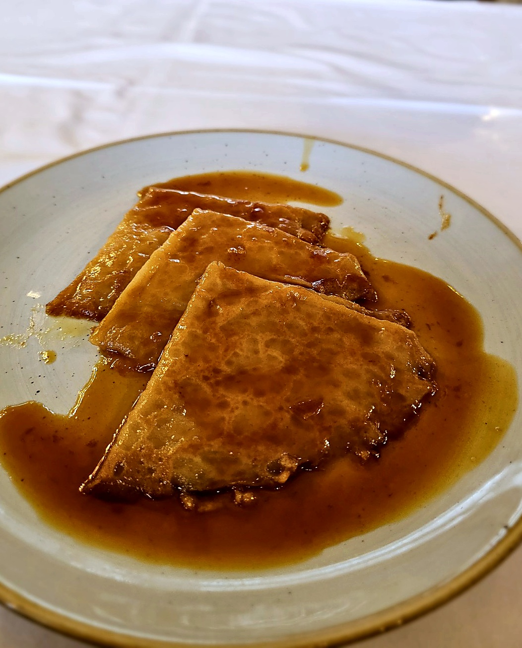 The finished crêpes, glazed in a rich citrus sauce — a suitably theatrical finale at Le Train Bleu.