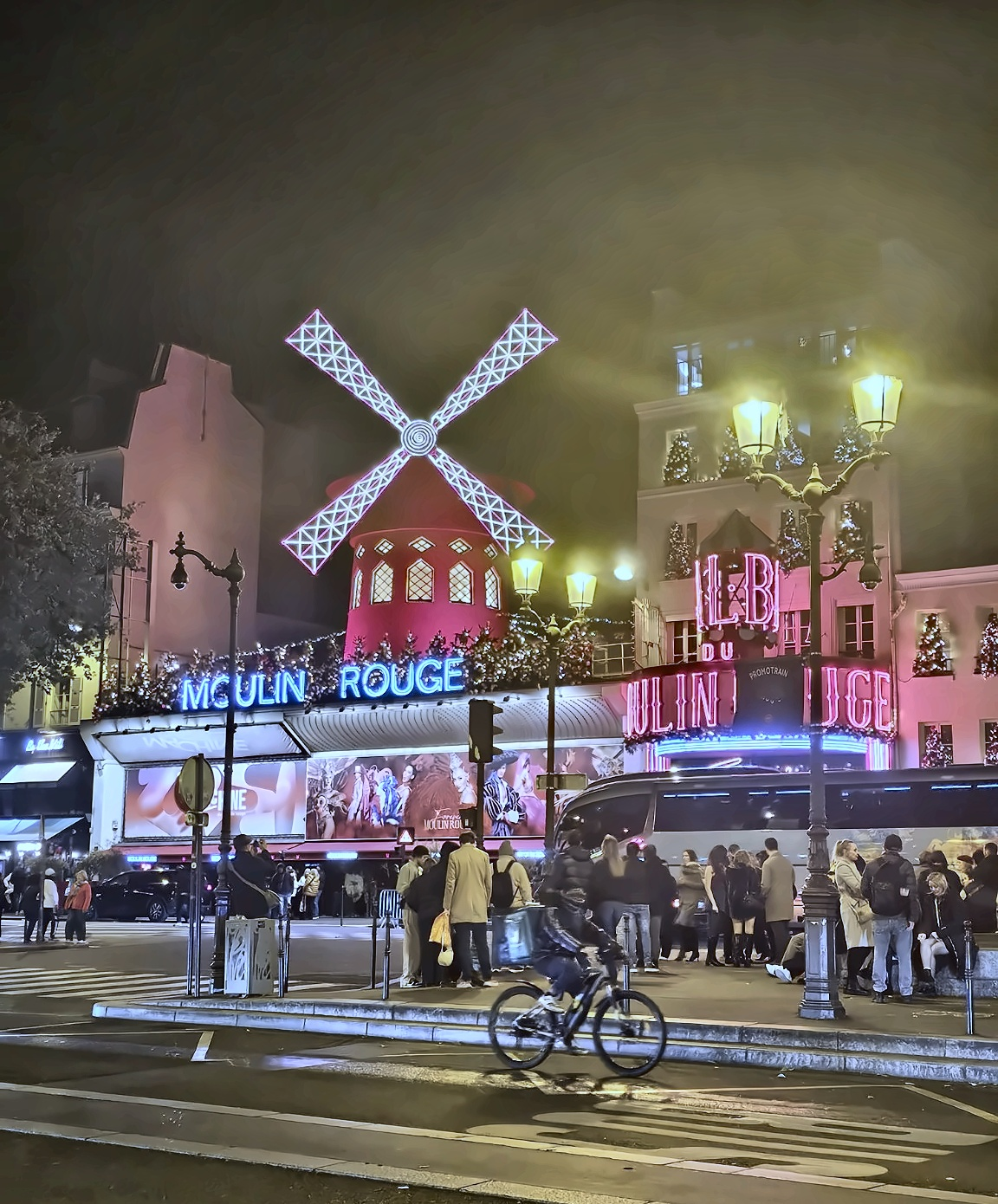 The Moulin Rouge at night — neon, traffic and the famous windmill announcing a second act very different from Mozart.
