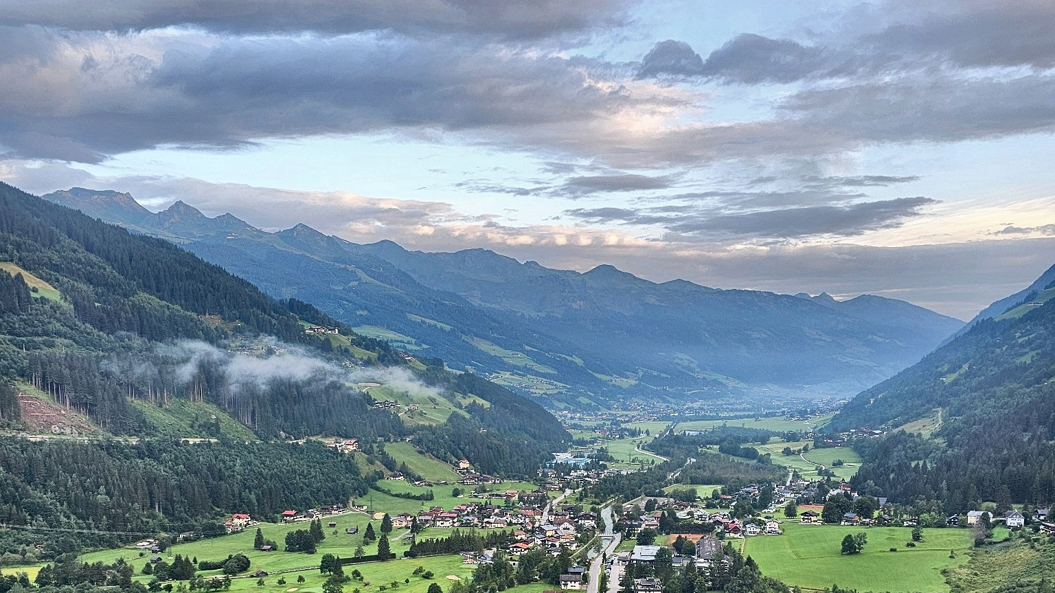 A few ribbons of morning mist above the Gastein Valley, seen from the balcony at the cōmodo.