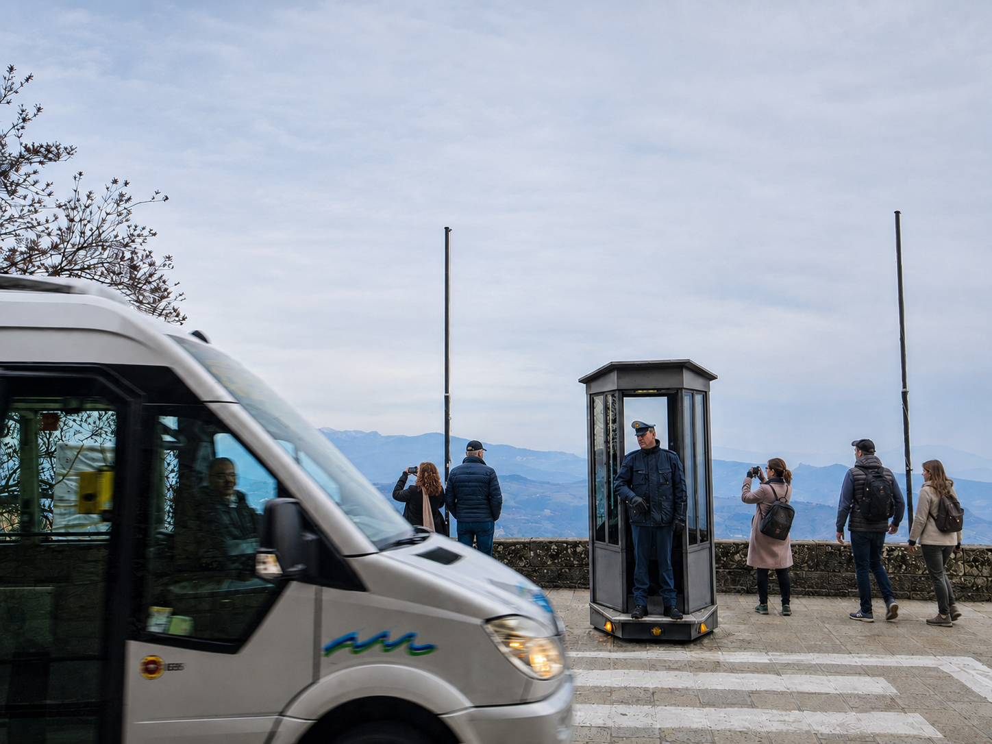A ceremonial guard in his glass booth, with the landscape behind and everyday life cutting across the scene.