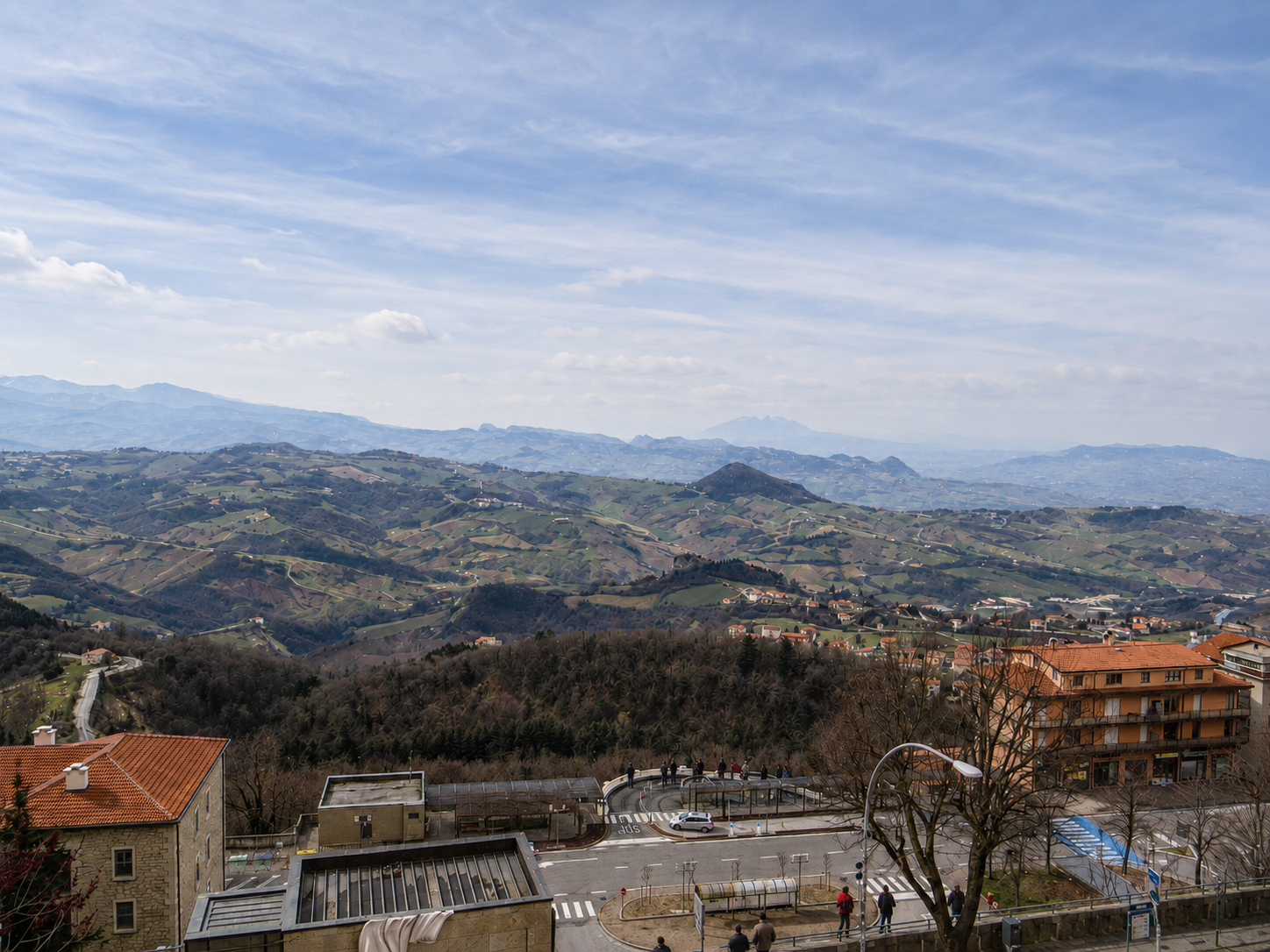 The view from Mount Titano, softened by haze but wide enough to explain why this tiny republic chose the mountain.