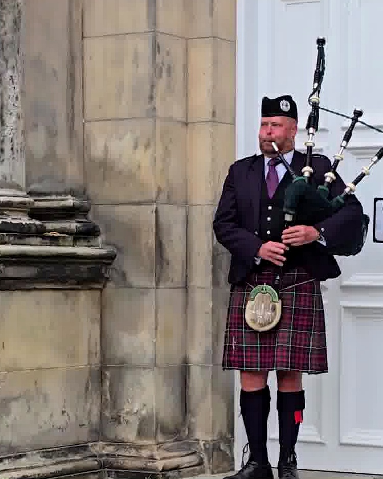 Because in St Andrews even a wet, grey afternoon can still come with a bagpiper on cue.
