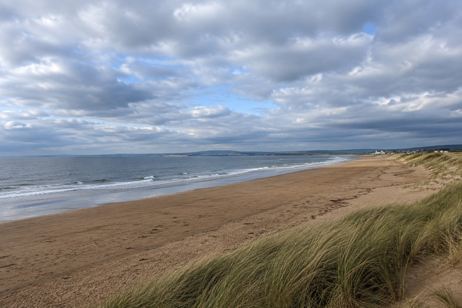 West Sands unfolding beneath a sky large enough to make even St Andrews feel small.