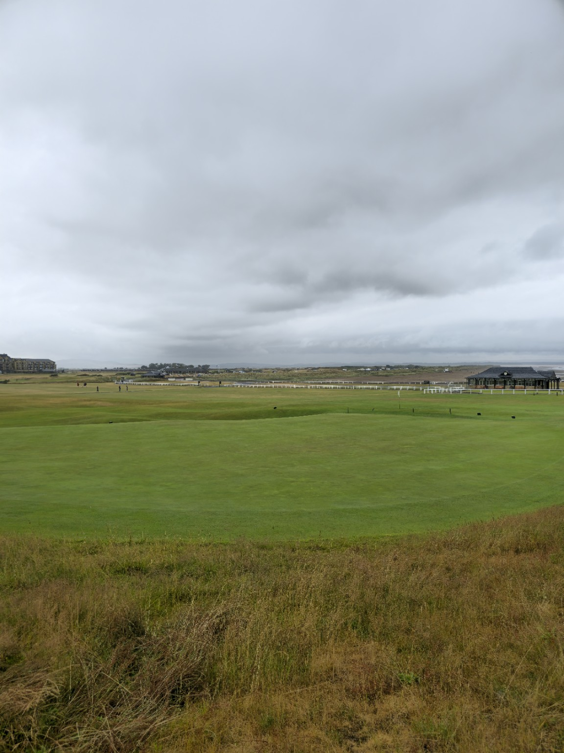 The Old Course stretching towards the hotel, where six centuries of history meet the considerably newer business of selling the view.