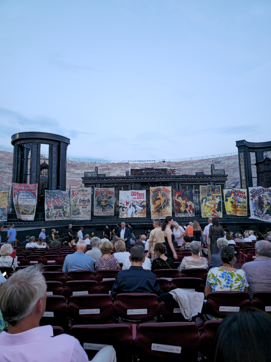 The stage before the performance, wrapped in Belle Époque posters and waiting for Paul Curran’s Paris to come alive.