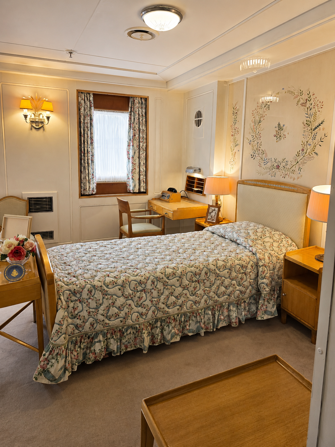Royal status, floral bedspread and remarkably little theatricality: Queen Elizabeth II’s bedroom aboard Britannia.