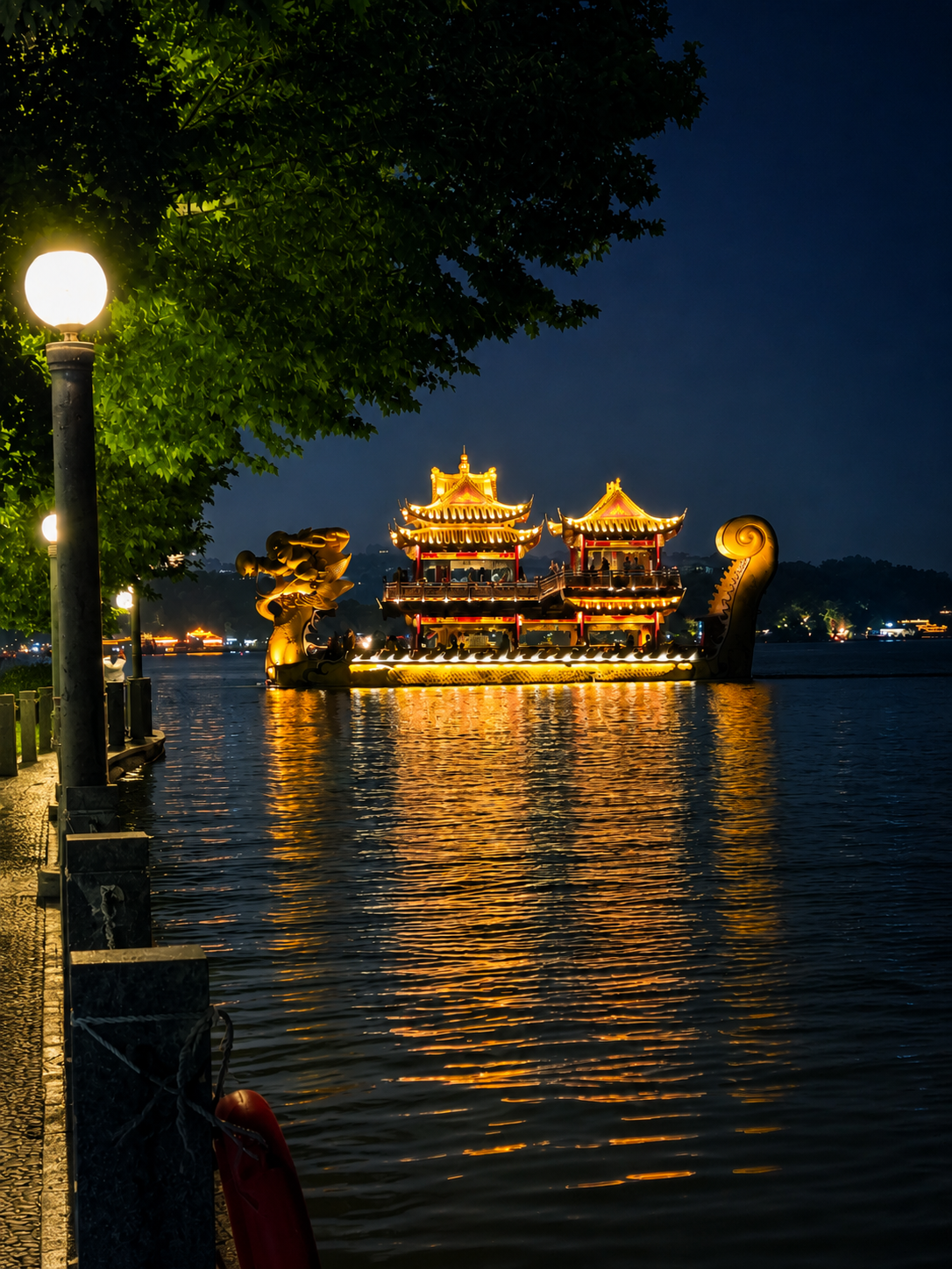 An illuminated traditional-style pleasure boat on West Lake during my first evening in Hangzhou.