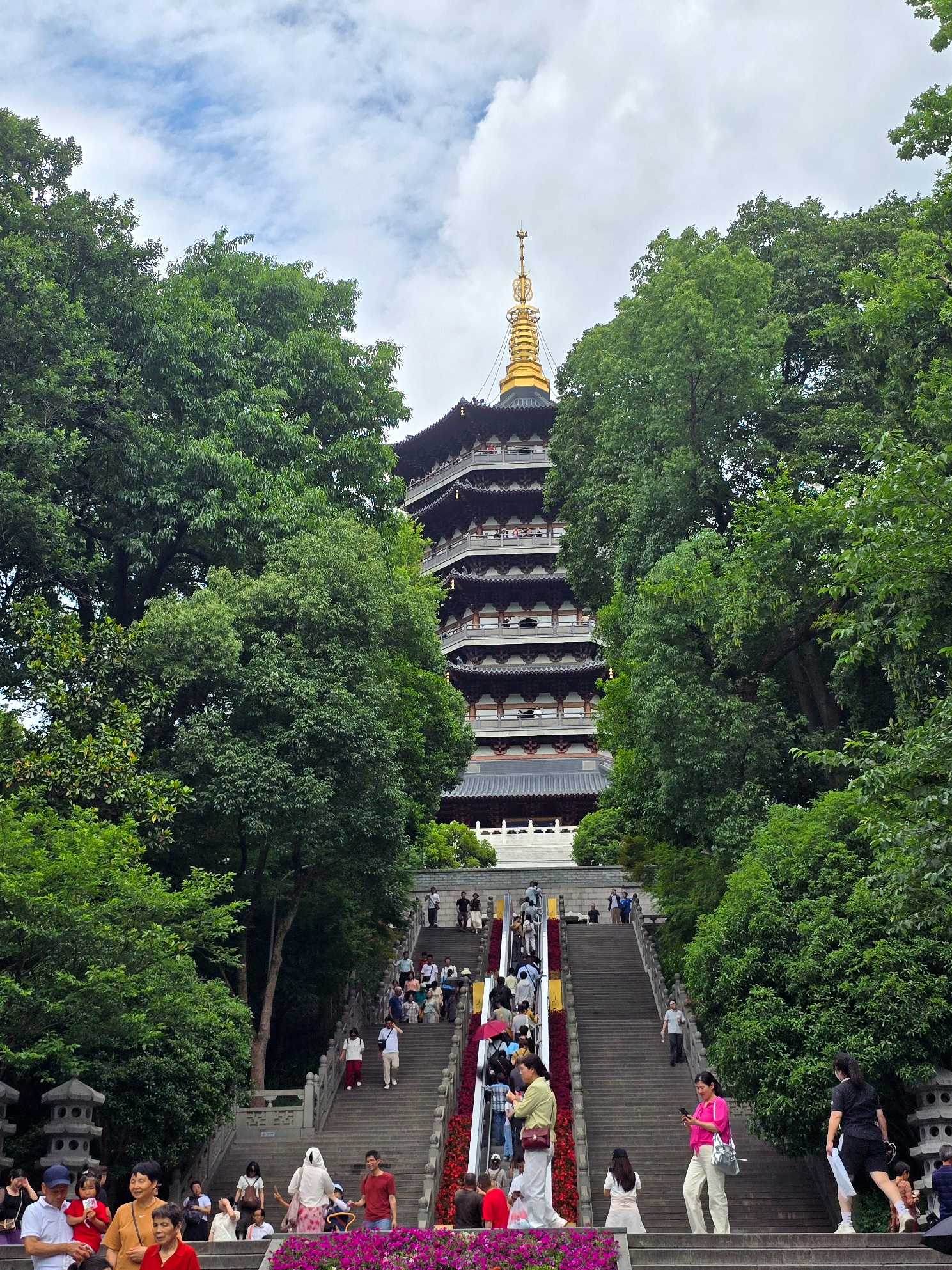 Approaching Leifeng Pagoda through the trees, with the final staircase rising towards the tower.