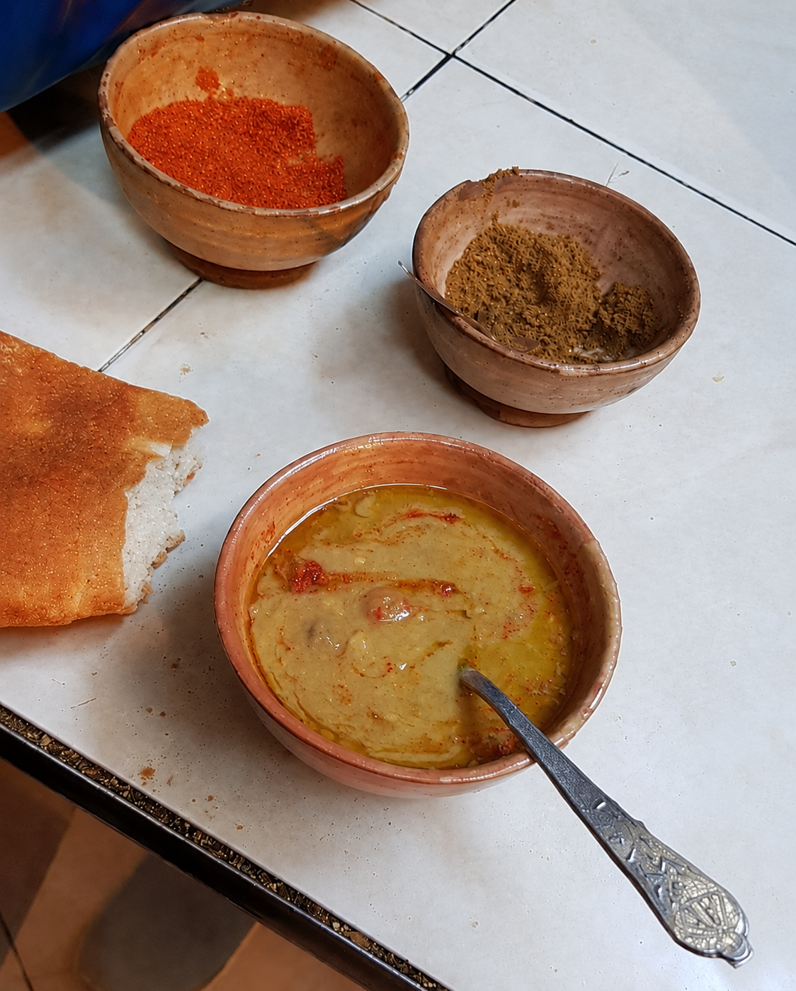 Harira in Fes — simple, thick, heavily seasoned and served with bread, while I remained considerably more suspicious of the spoon than of the soup.