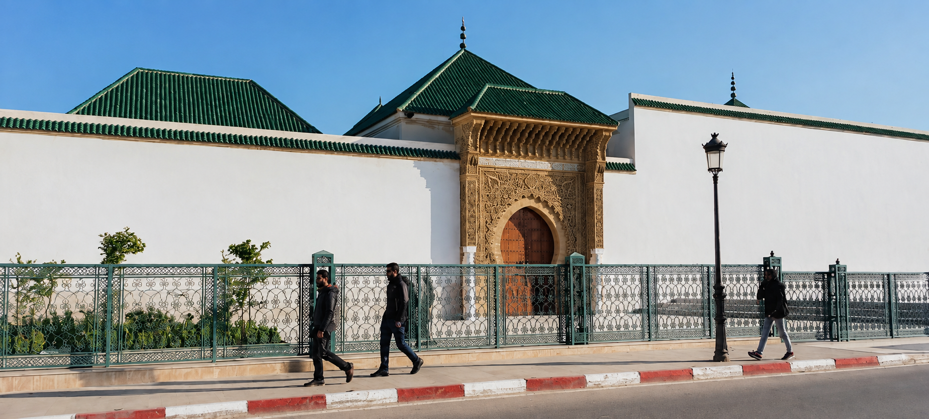 Mausoleum of Moulay Ismail with green-tiled roofs and an ornate gate in Meknes.
