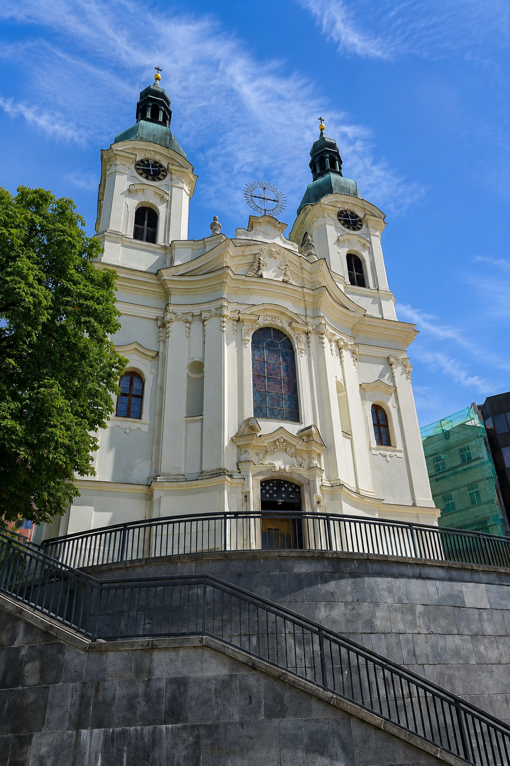 Baroque Church of Saint Mary Magdalene with twin towers above stone steps in Karlovy Vary.