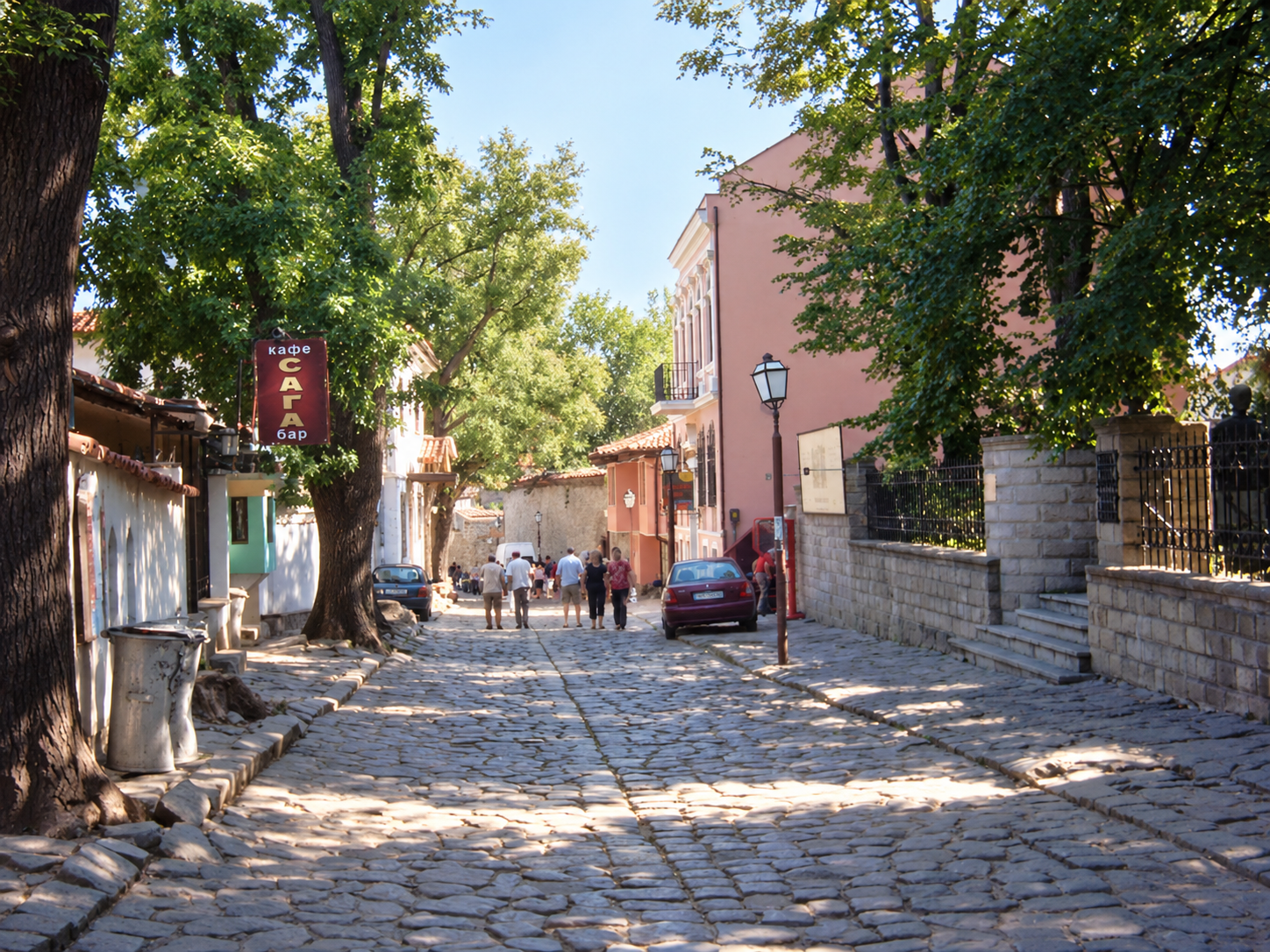 Cobbled street with pedestrians and cafés in Plovdiv's Old Town, Bulgaria.