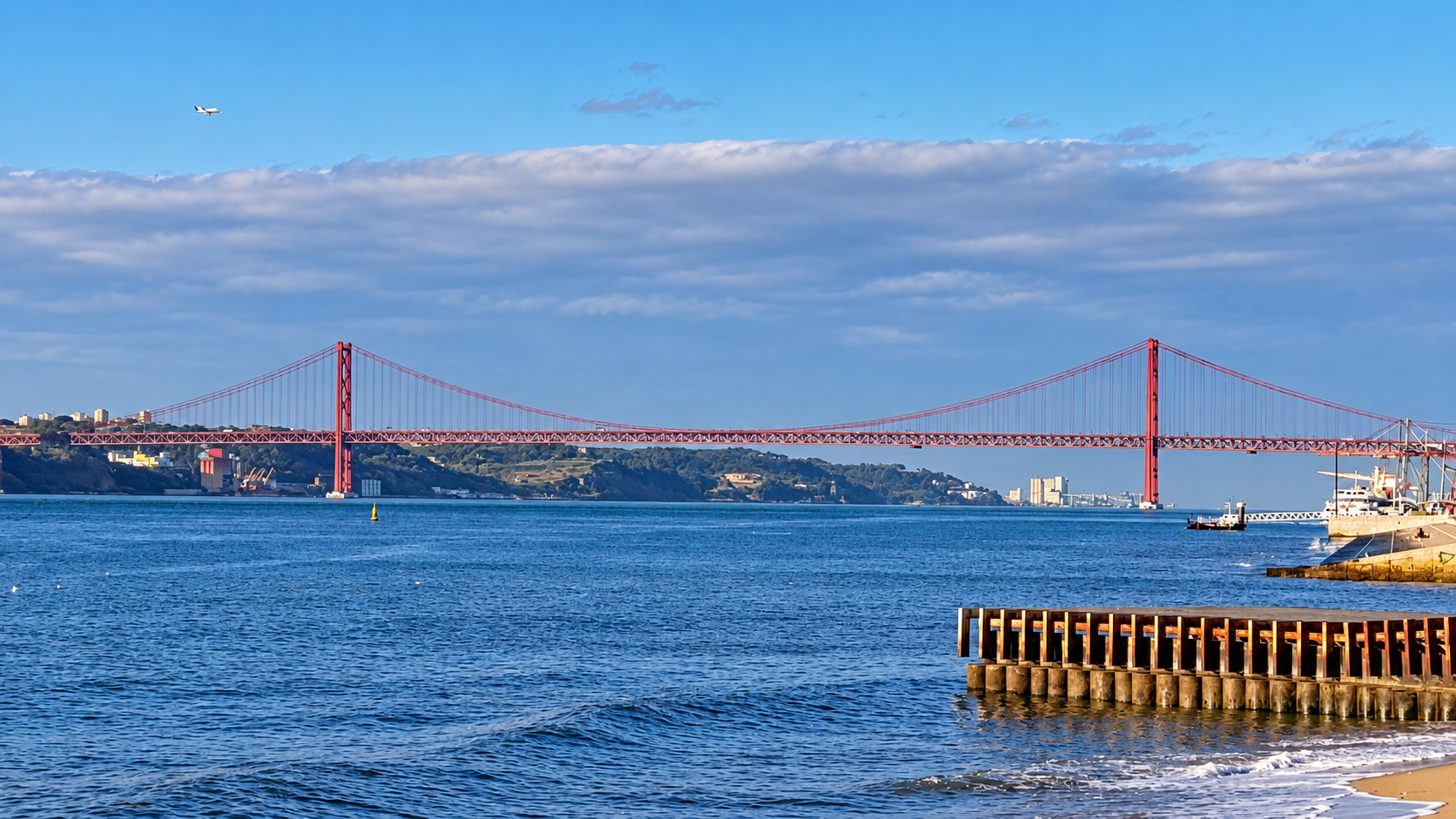Ponte 25 de Abril spans the Tagus River, with Lisbon’s shoreline beyond.