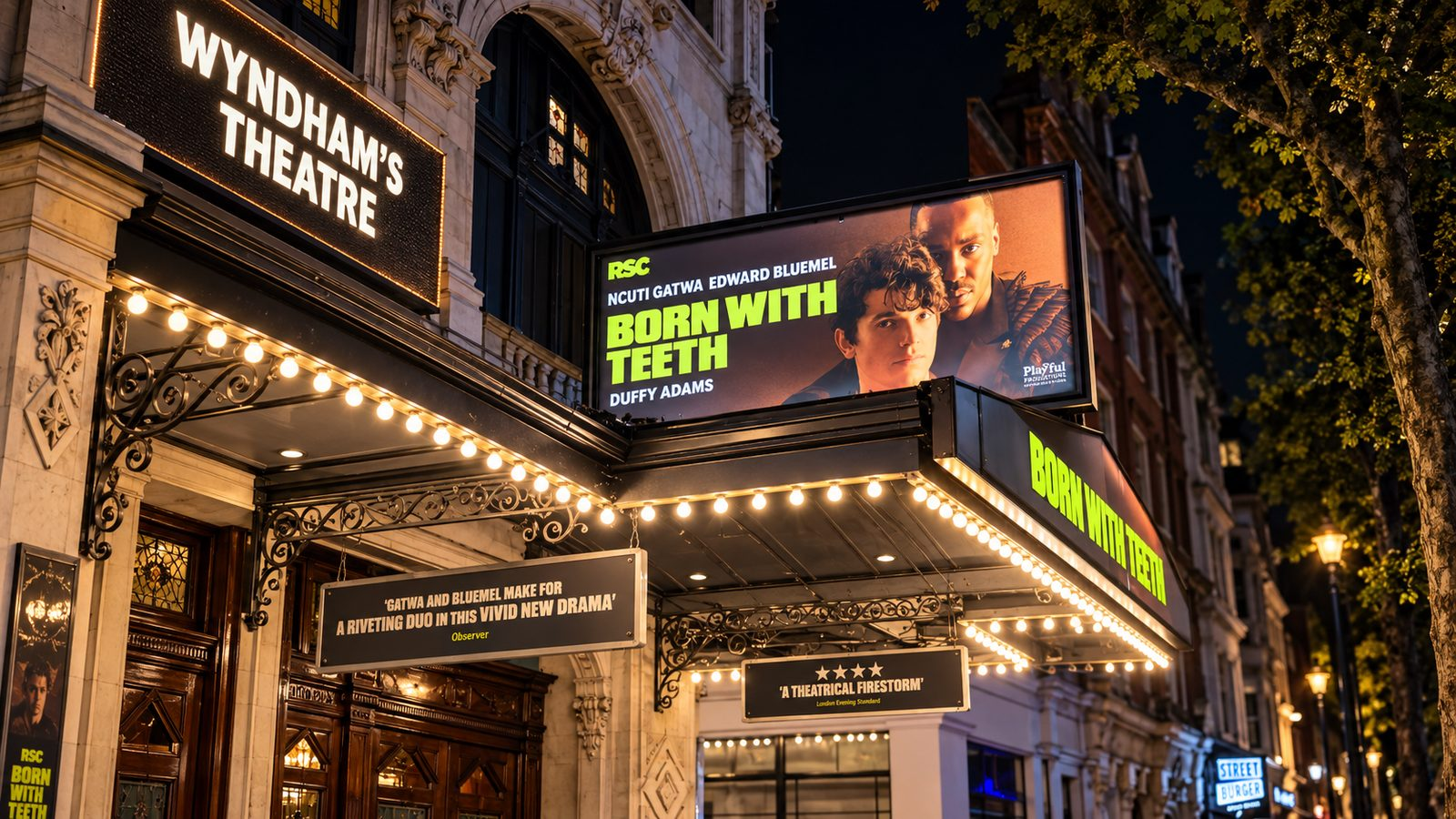 Wyndham’s Theatre marquee and Born With Teeth billboard glow above Charing Cross Road at night.