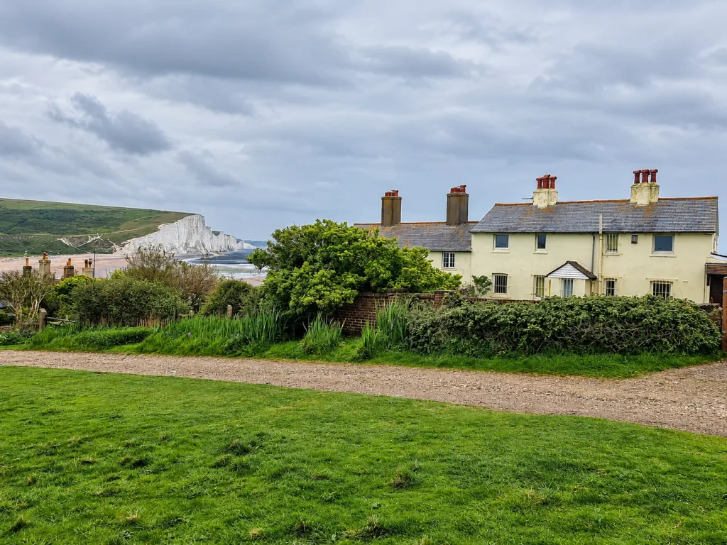 Coastguard Cottages and the Seven Sisters cliffs under cloudy skies in East Sussex