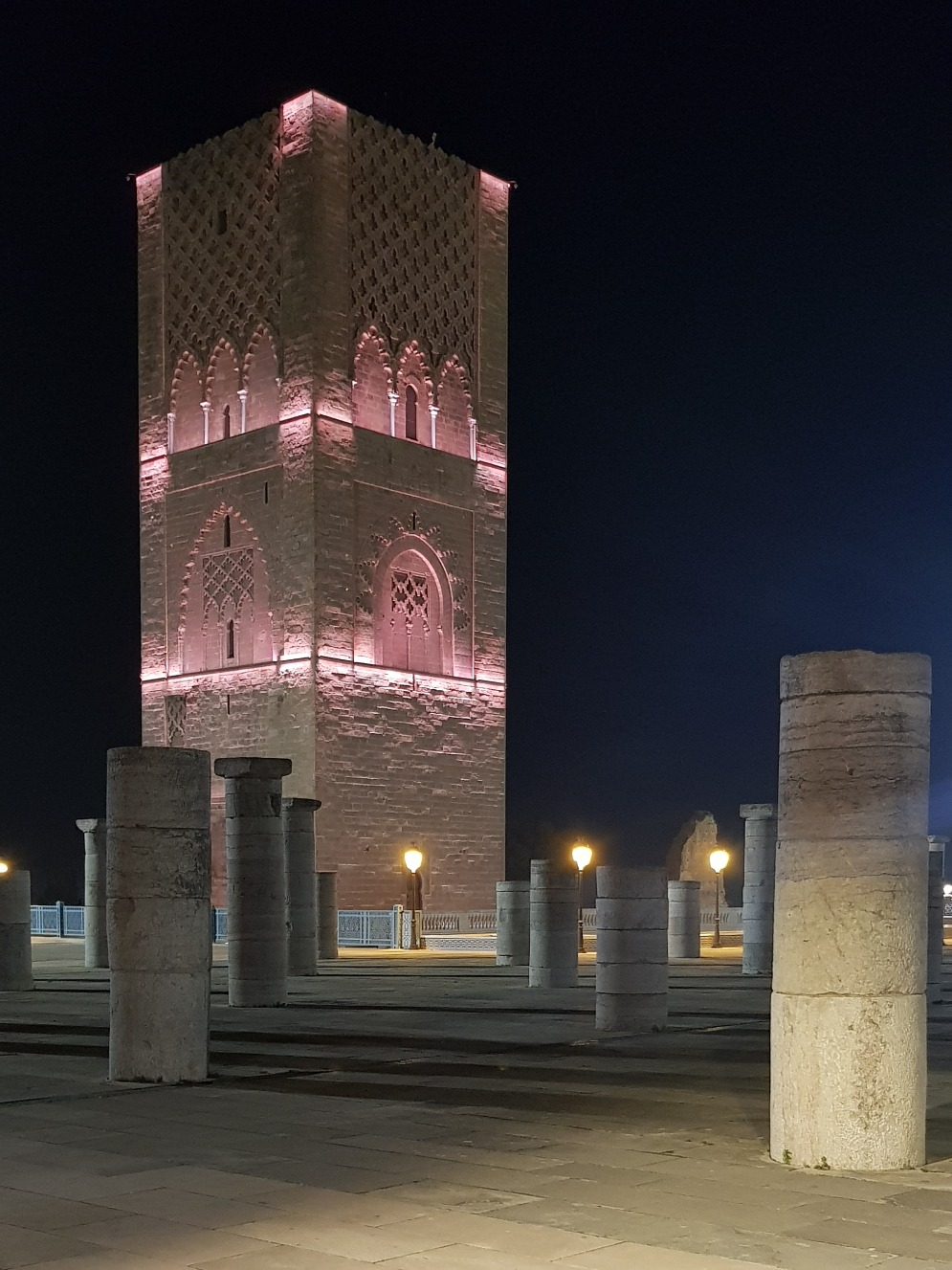 Hassan Tower and stone columns illuminated at night in Rabat.
