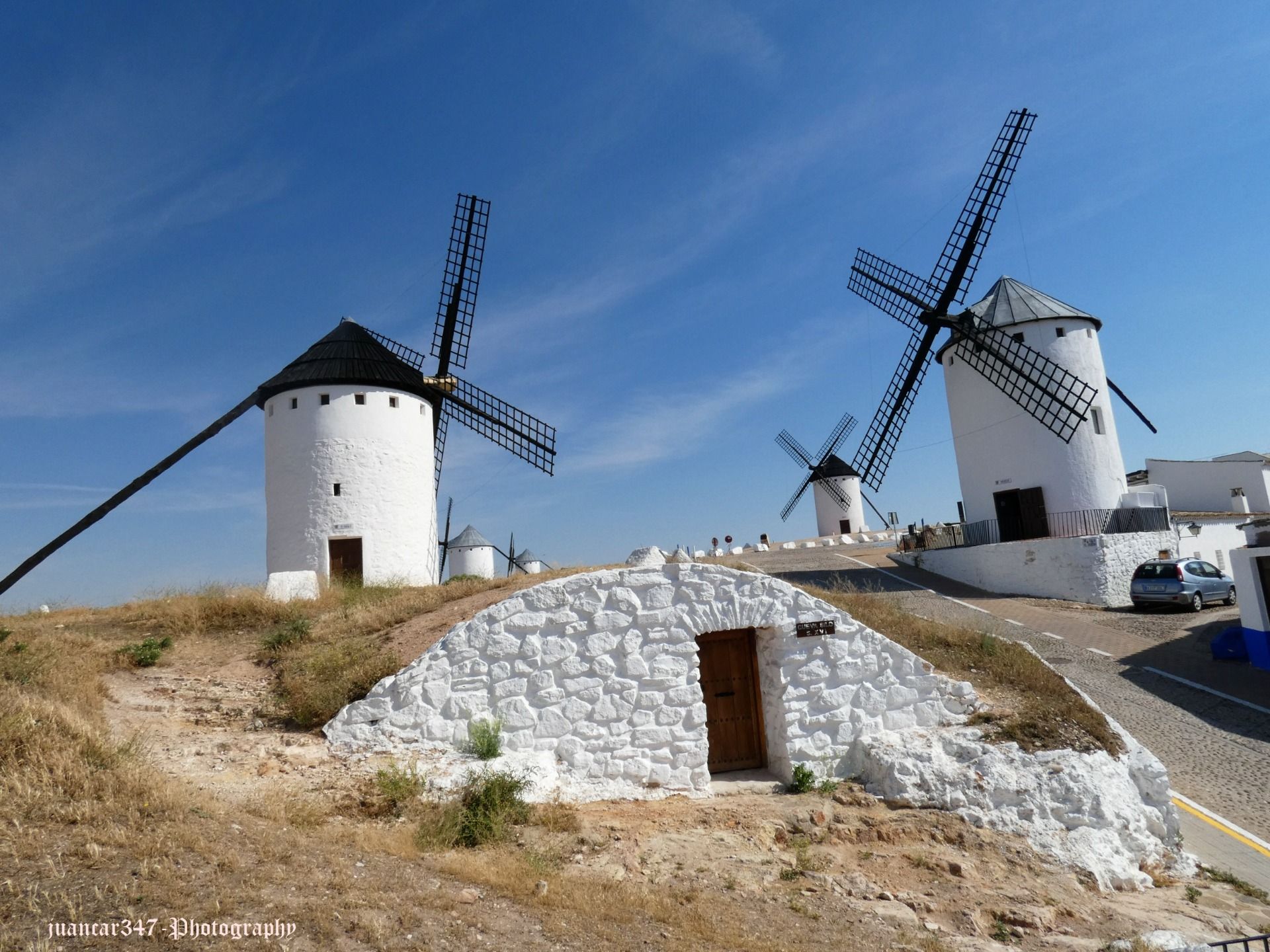 In the shadow of the mills: in the foreground, a cave house