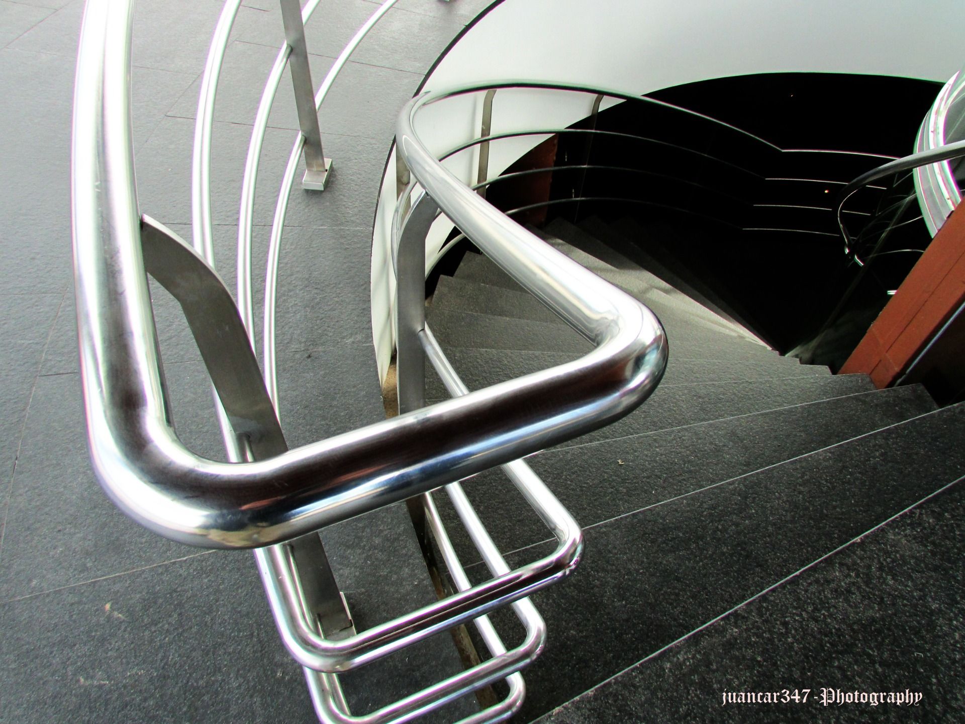 A modern spiral staircase into the cellars