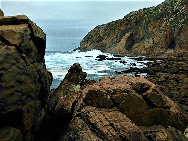 Exciting and dramatic shoreline with epic geological features in the distance