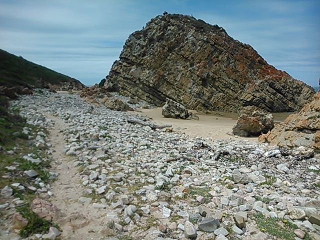 The trail leads on beyond Arch Rock to the east.