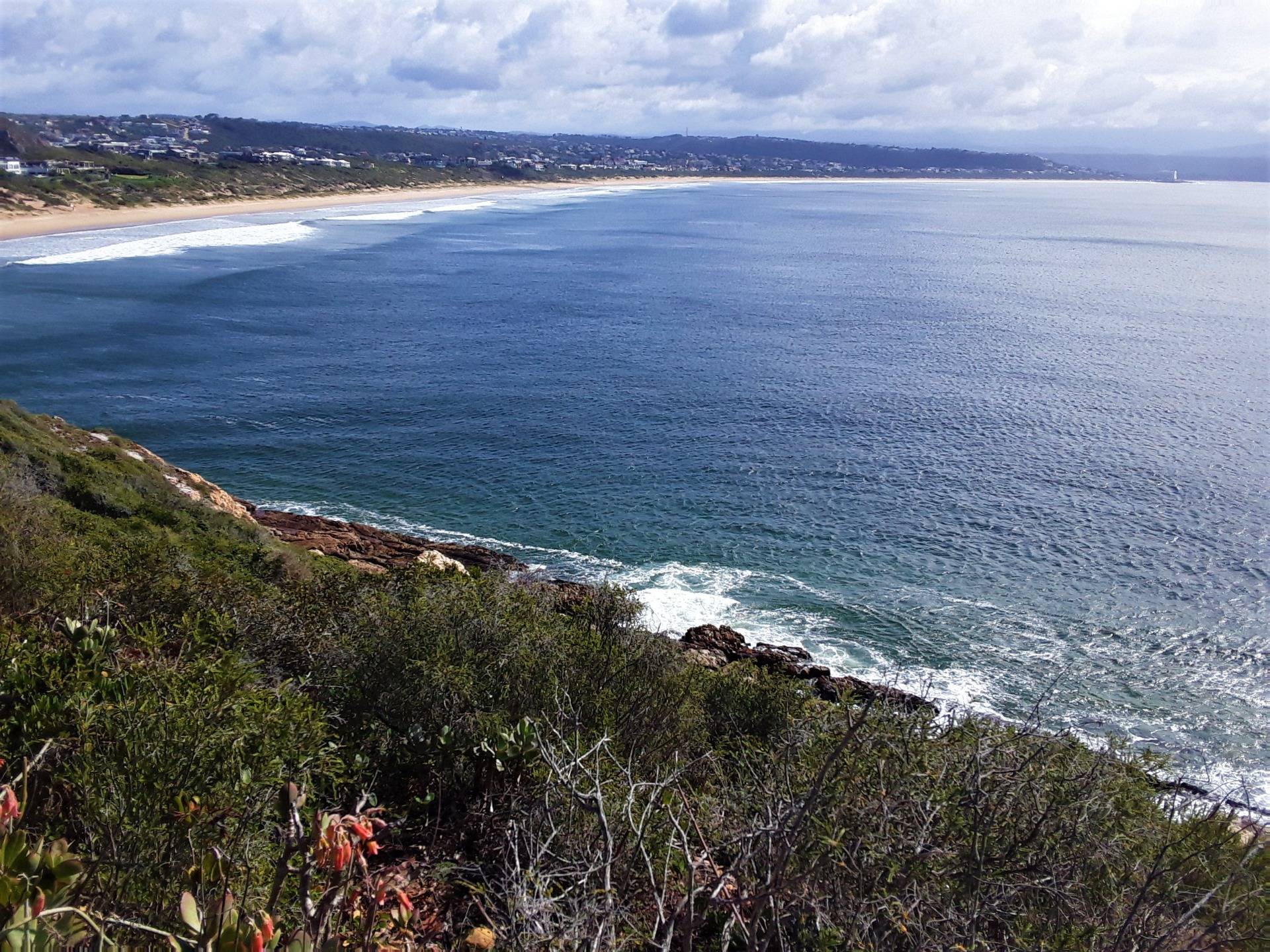The long stretch of Robberg beach with the town of Plettenberg Bay in the background