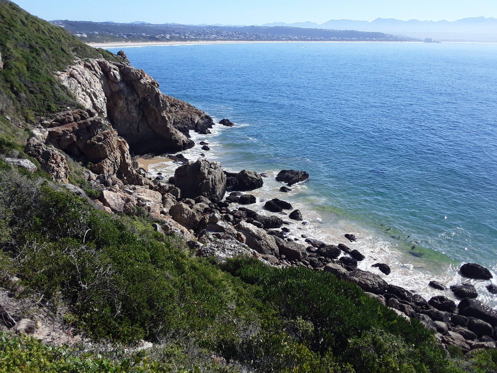 You can glimpse part of the seal colony below in the water, with RObberg beach in Plettenberg Bay in the distance