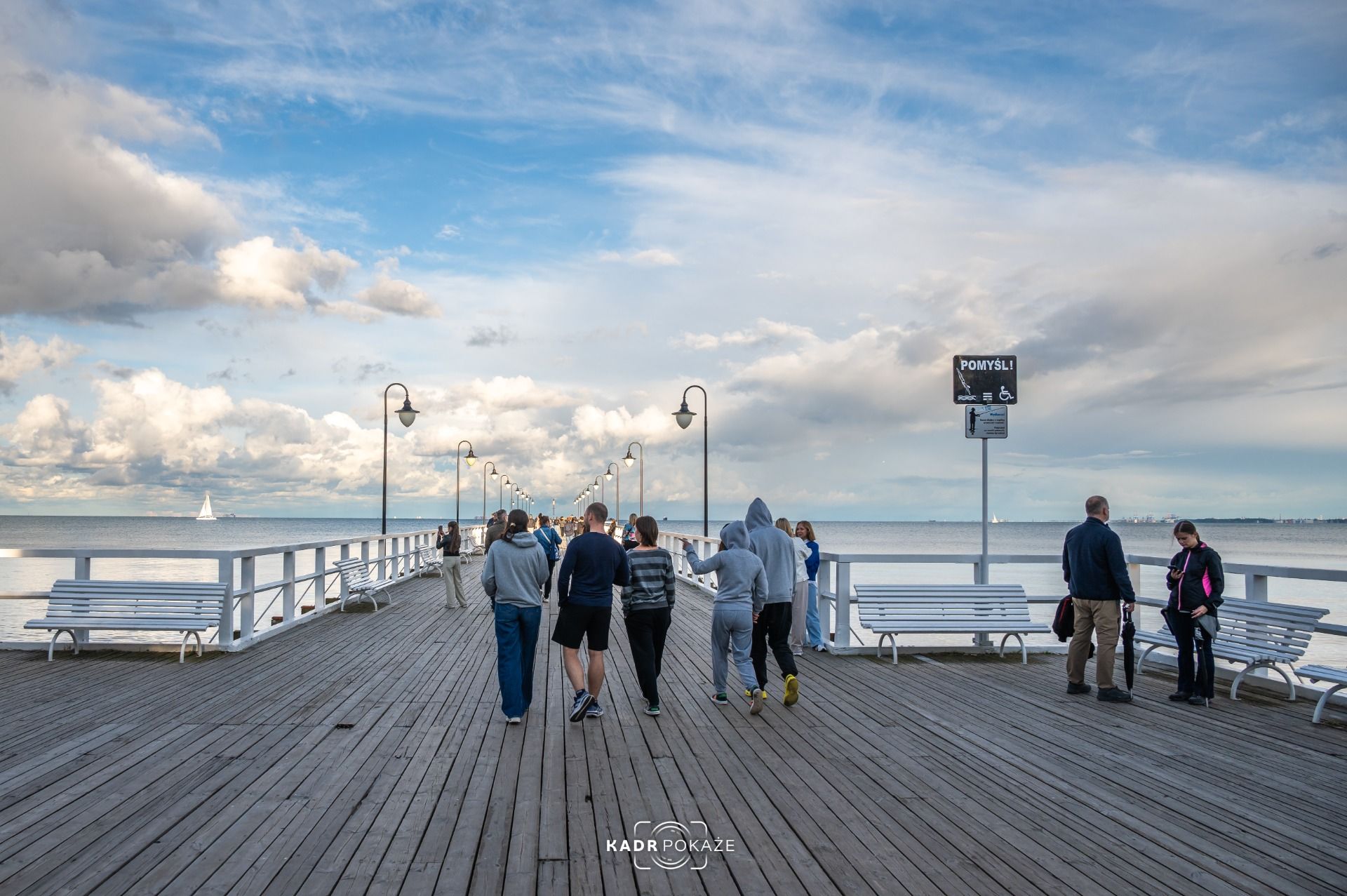 People walking on the pier.
