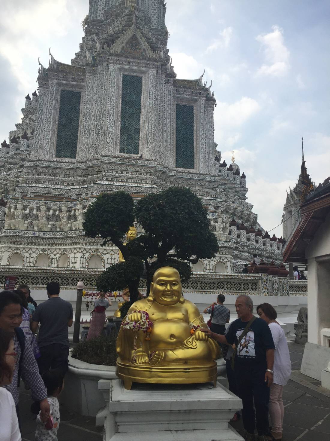 Right in front of the temple you will find a golden sitting Buddha.