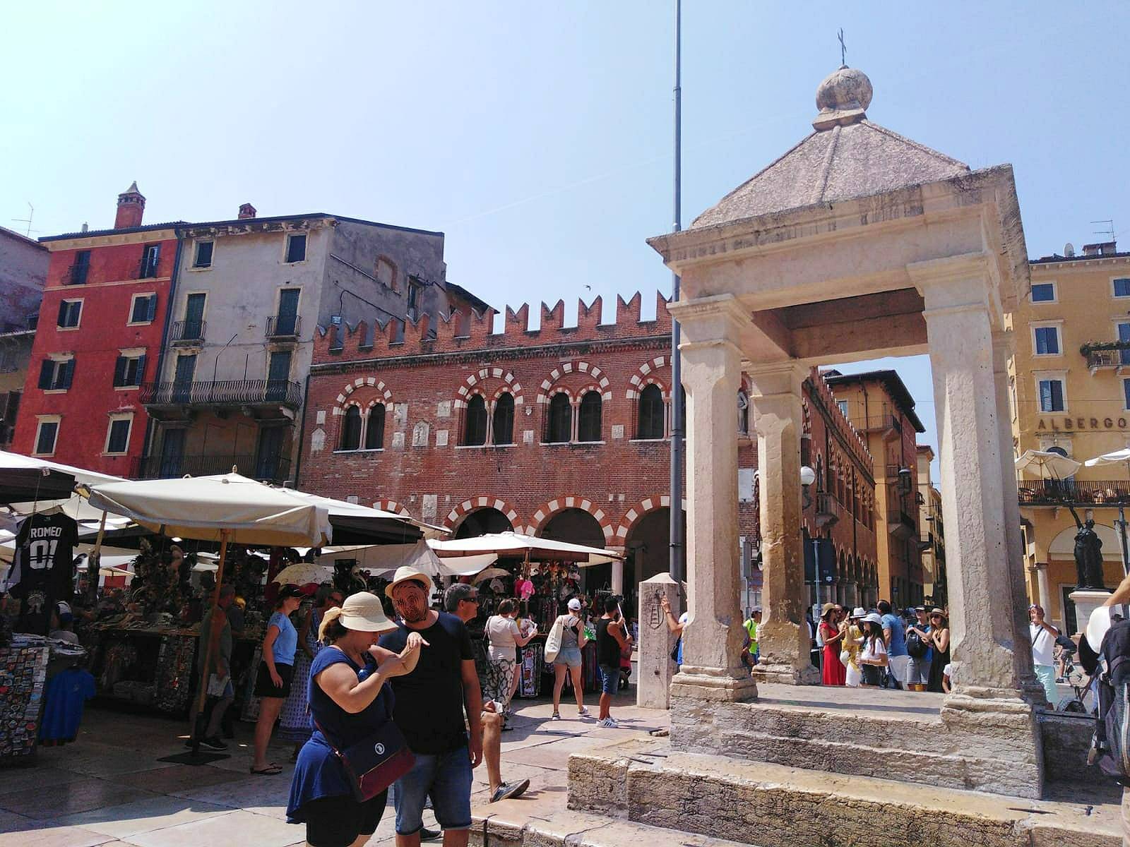 The lively city centre with the Torre dei Lomberti and the Piazza delle Erbe 