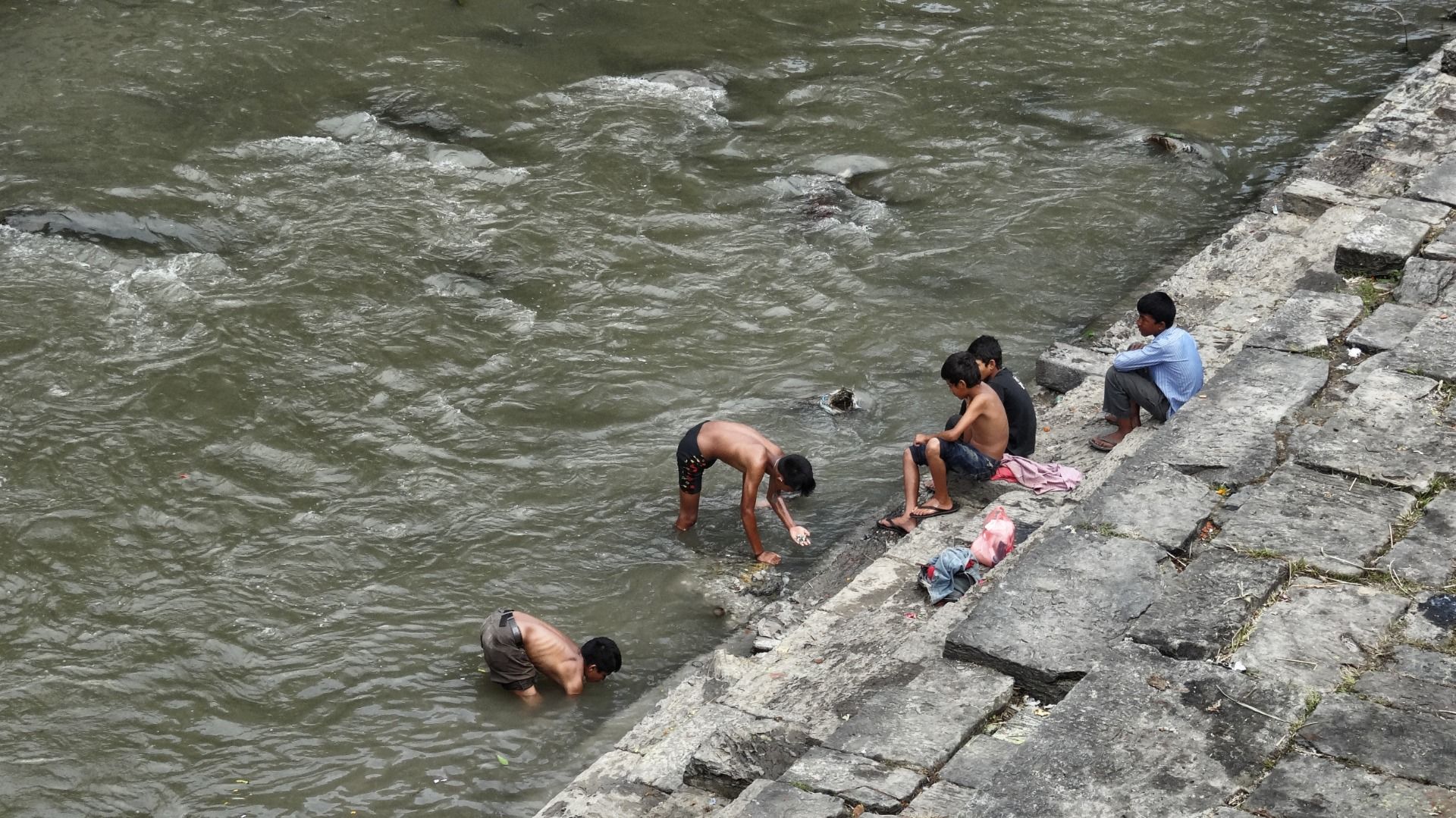 Diving boys. They’re searching for gold an silver.
