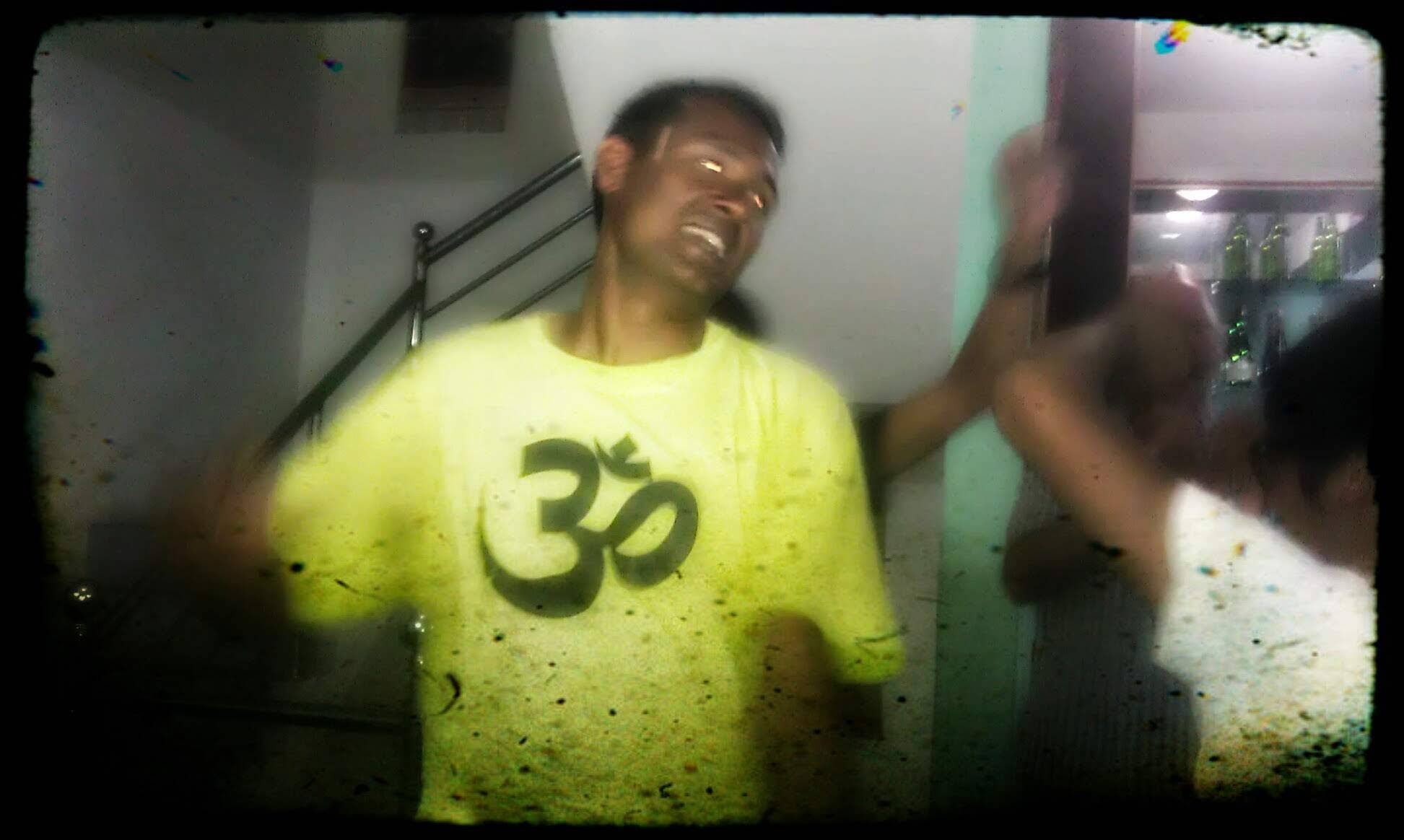 Dancing sherpa: The ”30” on his shirt means not thirty, it means ”om”: ॐ