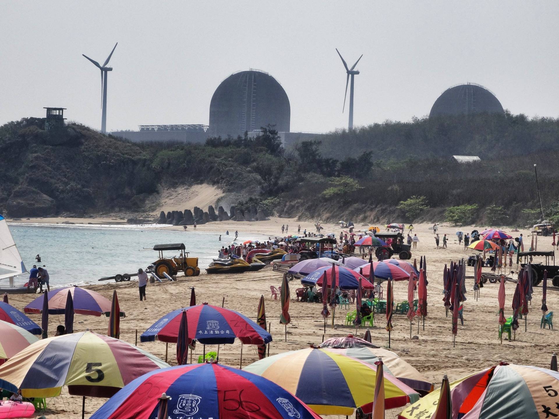 Strange beach: Bathing in the shadow of a nuclear power plant.