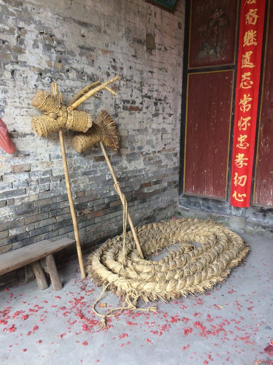 This is a dragon decoration made of straw, which village members used on New Years Day and dance with it. People use firecrackers to expel the evil spirits away then welcome good spirits.