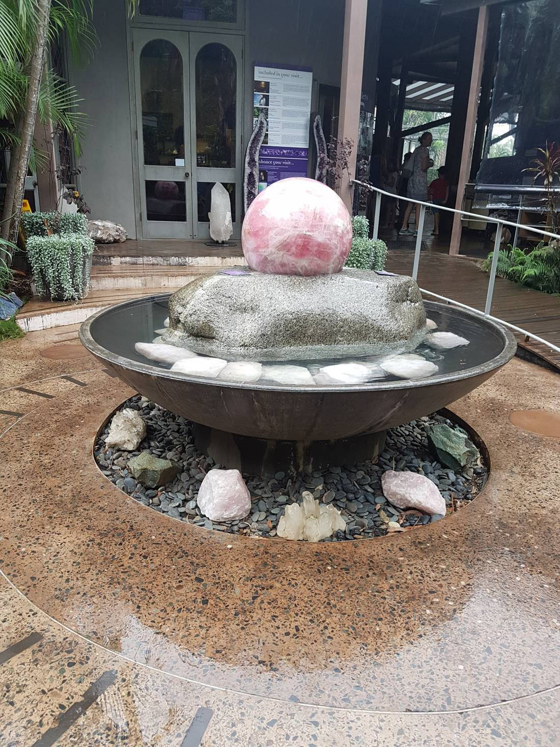The rose quarts sphere was floating and spinning on the fountain.