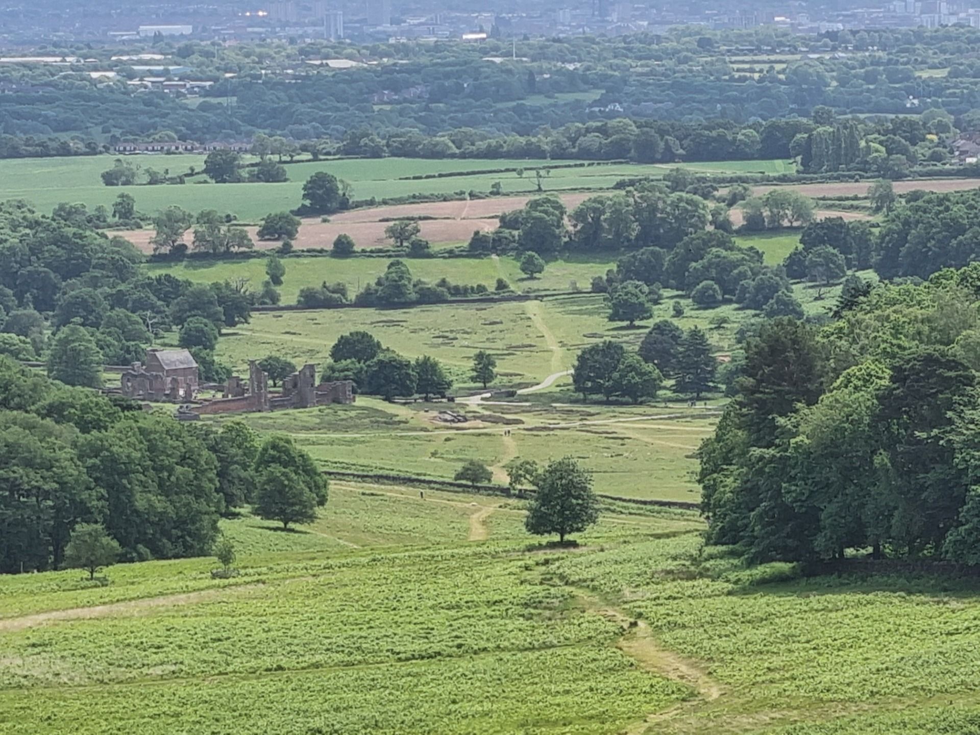 The old manor house in the for ground and the city of Leicester on the horizon.