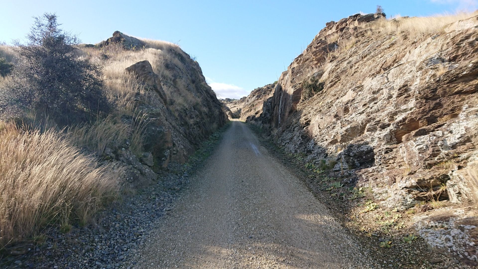 Just before the tunnel, the trail cuts through the rock...