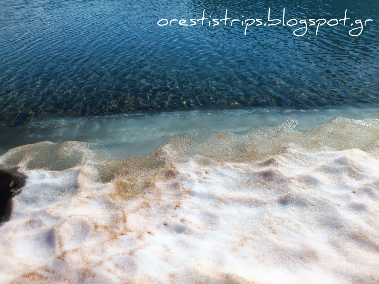 All stages in one image: Snow with ice underneath, melting ice, water.