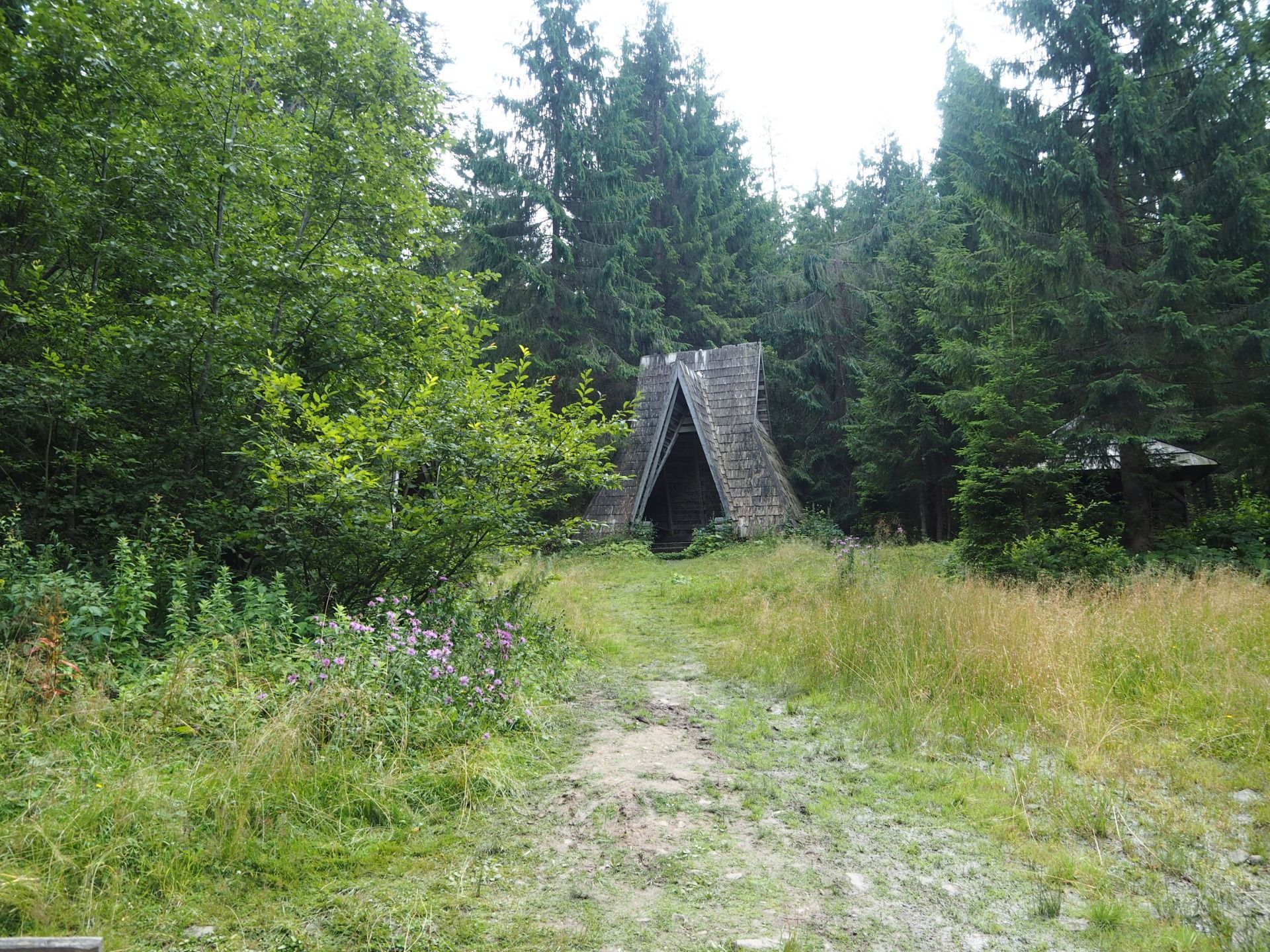 Old wooden gazebo for relaxation by the lake