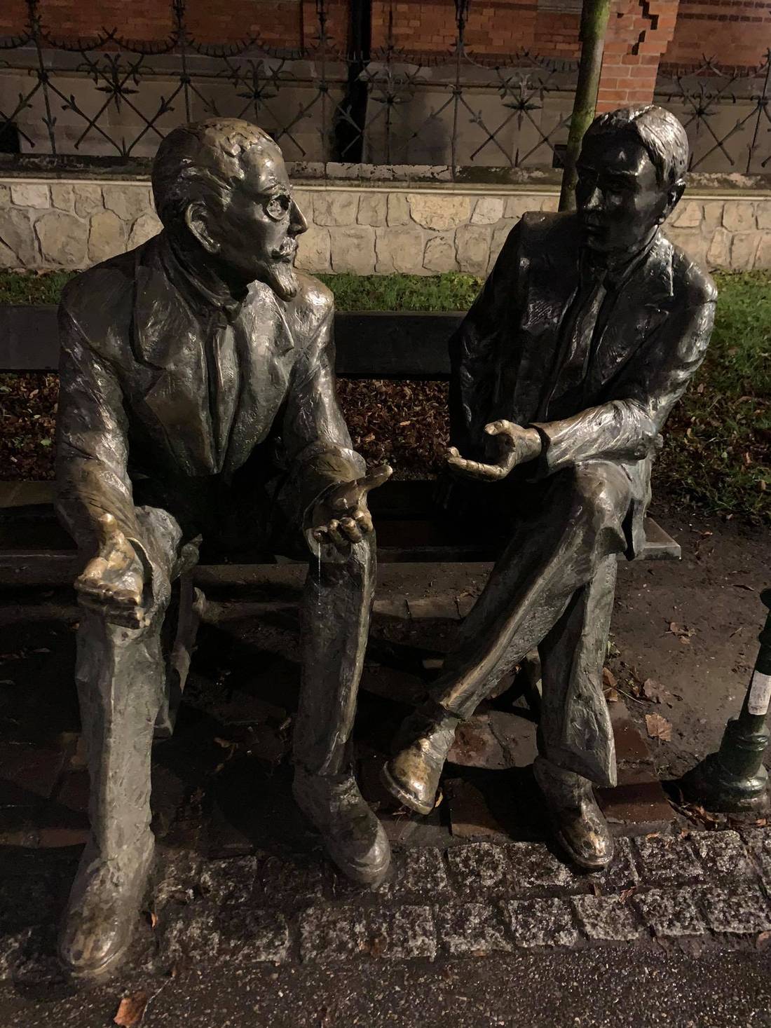 Two students on a bench in Planty park, Kraków