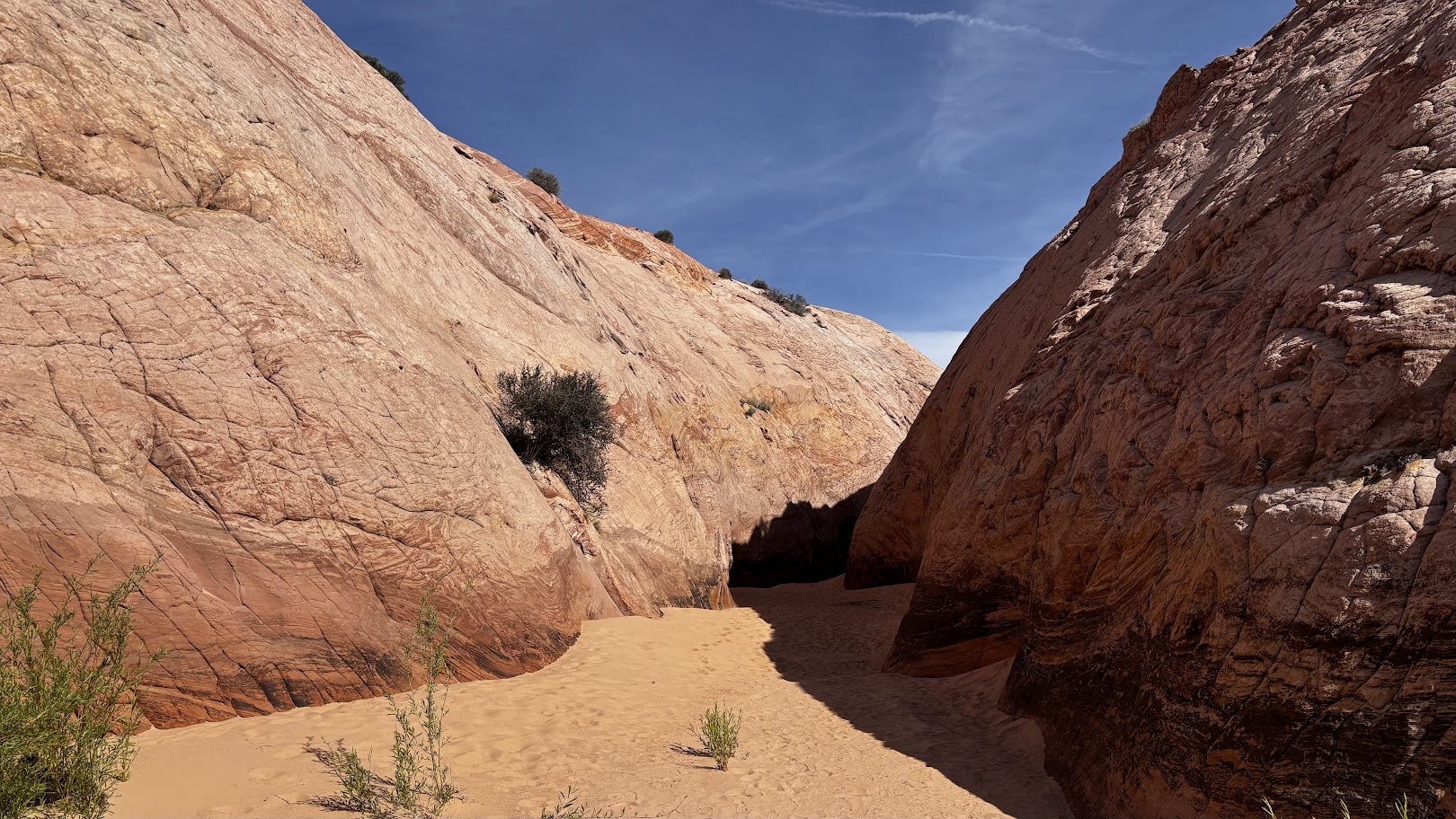 sand wash between red sandstone rocks at the entrance of Zebra Slot Canyon, Utah
