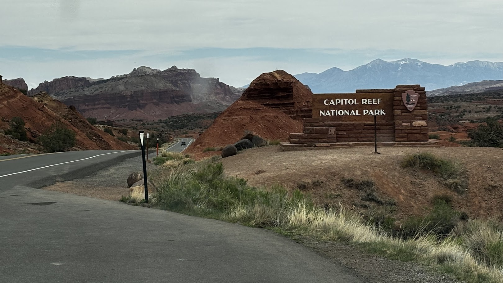 Capitol Reef National park welcome sign with Henry Mountains visible in the background